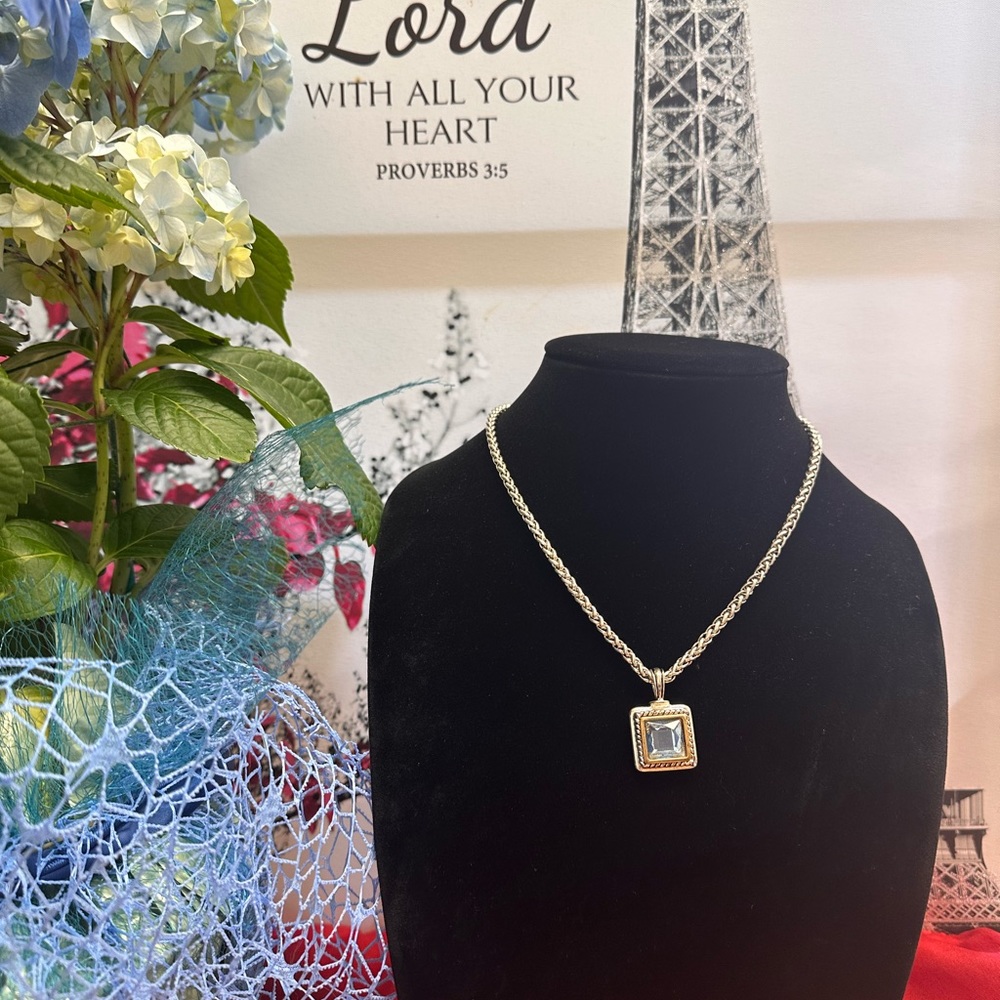 silver tone necklace with silver tone pendant with blue topaz stone